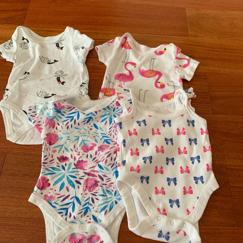 Multiple baby bodysuits.